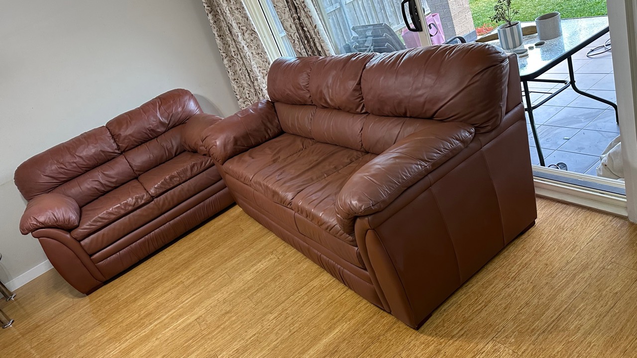 Brown leather two-seat and three-seat lounge suite