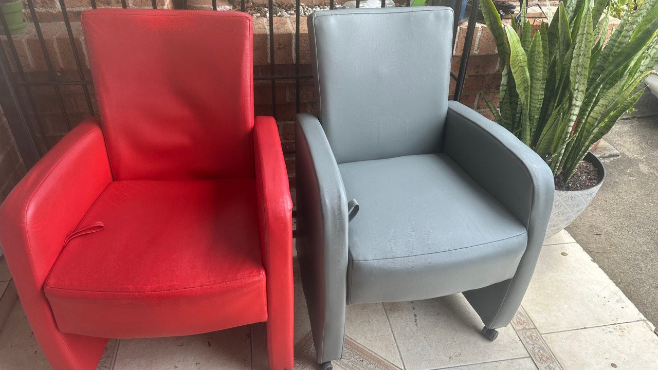 Red and grey upholstered armchairs shown together